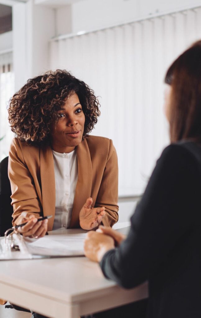 Young woman doing a job interview in the office and talking with client
